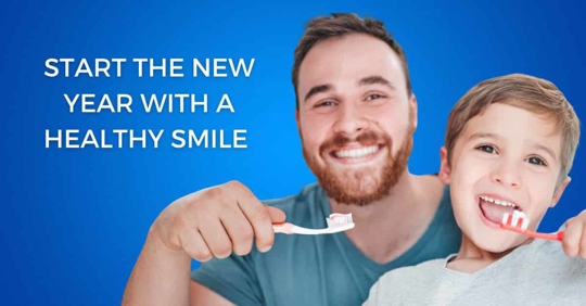 A father and son brushing their teeth - Start the new year with a healthy smile