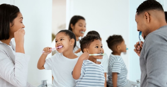 Parents brushing teeth with children