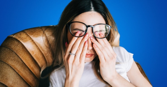 Tired woman rubbing her eyes
