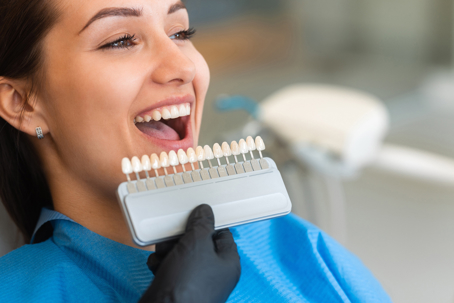 Woman comparing teeth whitening results
