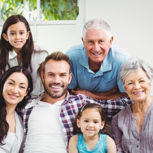 family sitting together on couch smiling