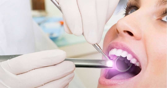 Doctor checking patient's teeth