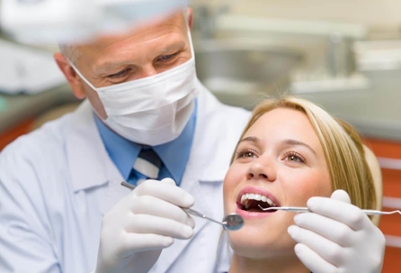 Doctor checking patient's teeth