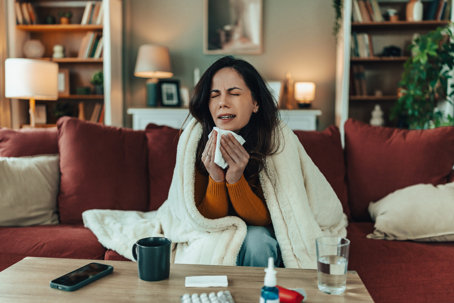 Woman on the couch sick with the flu