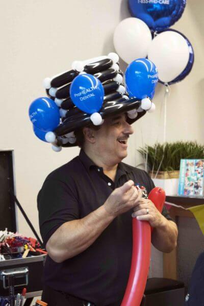 Man with balloon hat